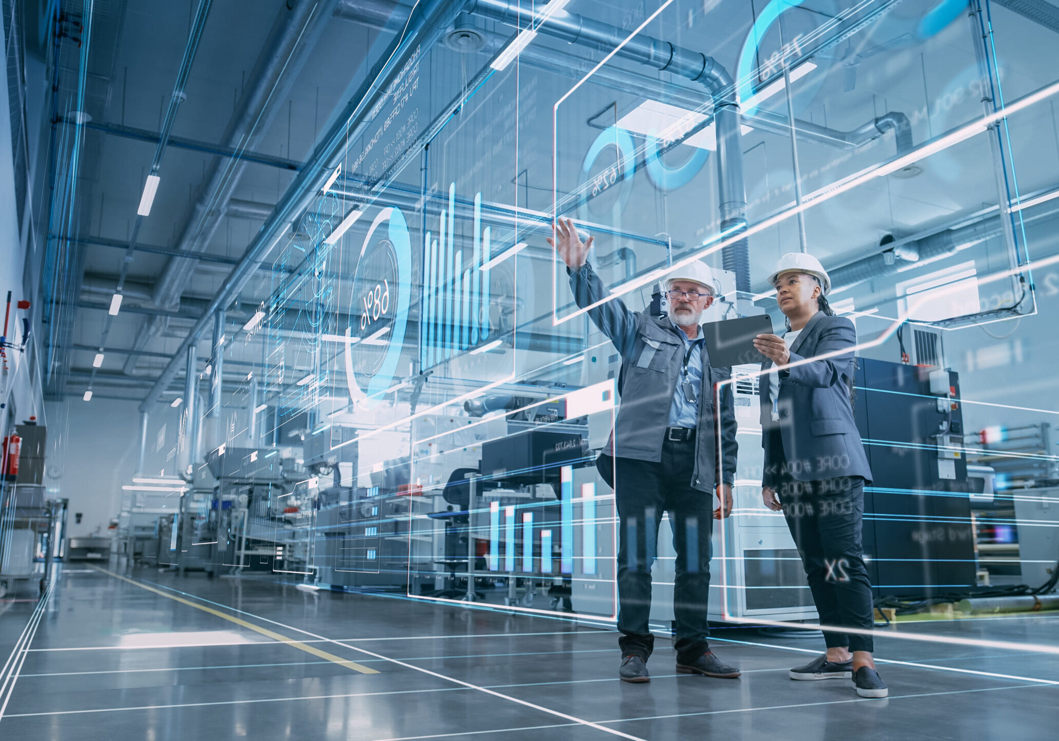 Factory Digitalization: Two Industrial Engineers Use Tablet Comp